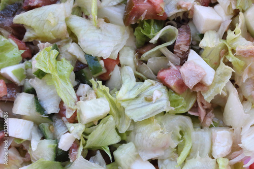 A closeup of a lettuce, tomato, cucumber, mozzarella cheese and other vegetables salad, with tuna, typical of italian mediterranean cuisine