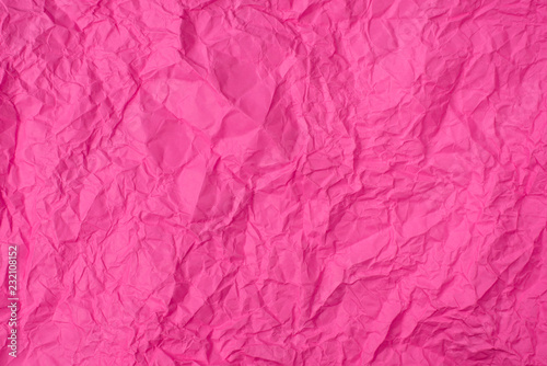 pink crumpled paper texture as background. concept of school, abstract and stress