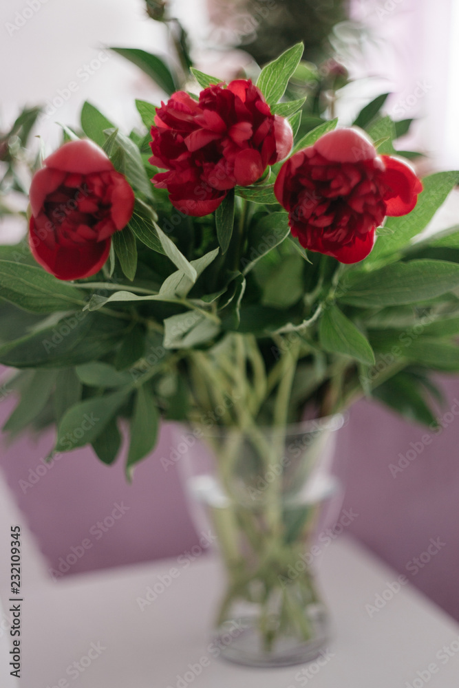 bouquet of red peonies in a vase on the white chair, wedding decoration bouquet of red peonies in a vase on the white chair, wedding decoration