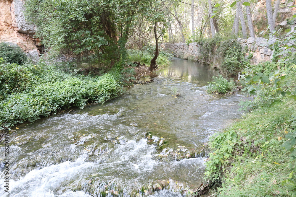 The Mesa river next to some rocks and a path in the Los Prados forest next to the rural small town of Jaraba, in Aragon region, Spain The Mesa river next to some rocks and a path in the Los Prados forest next to the rural small town of Jaraba, in Aragon region, Spain