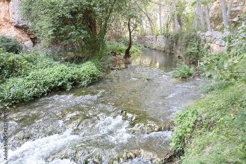 The Mesa river next to some rocks and a path in the Los Prados forest next to the rural small town of Jaraba, in Aragon region, Spain