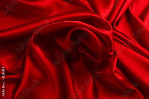 Red silk or satin luxury fabric texture can use as abstract background. Top view