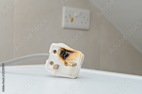 Burned 250V uk style socket and converter. Improper use of AC Power Plugs and Sockets cause of short circuit and fires at home photo