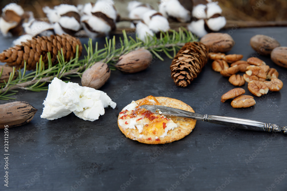 Fototapeta premium Rustic Cheese Tray with Crackers, Pecans, Herbs and Cracker