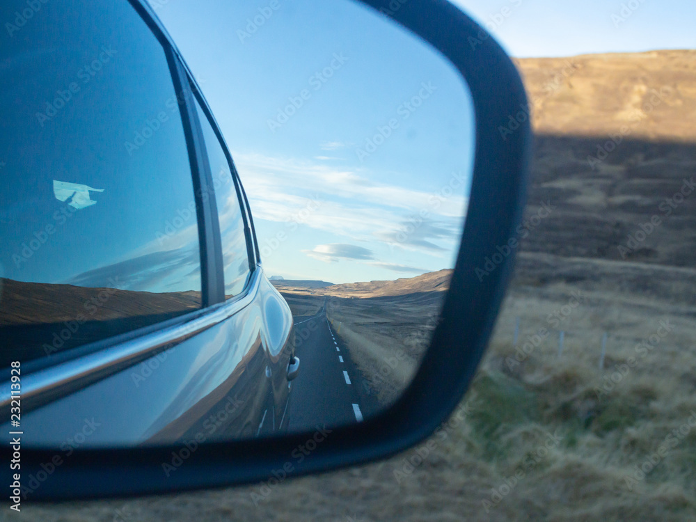 Iceland route one road in the car mirror rear view