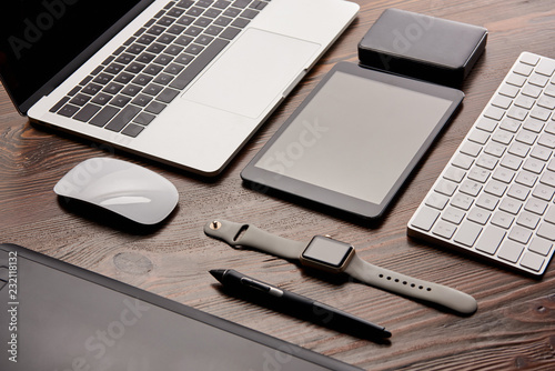 close-up shot of different modern gadgets on cg artist workplace photo