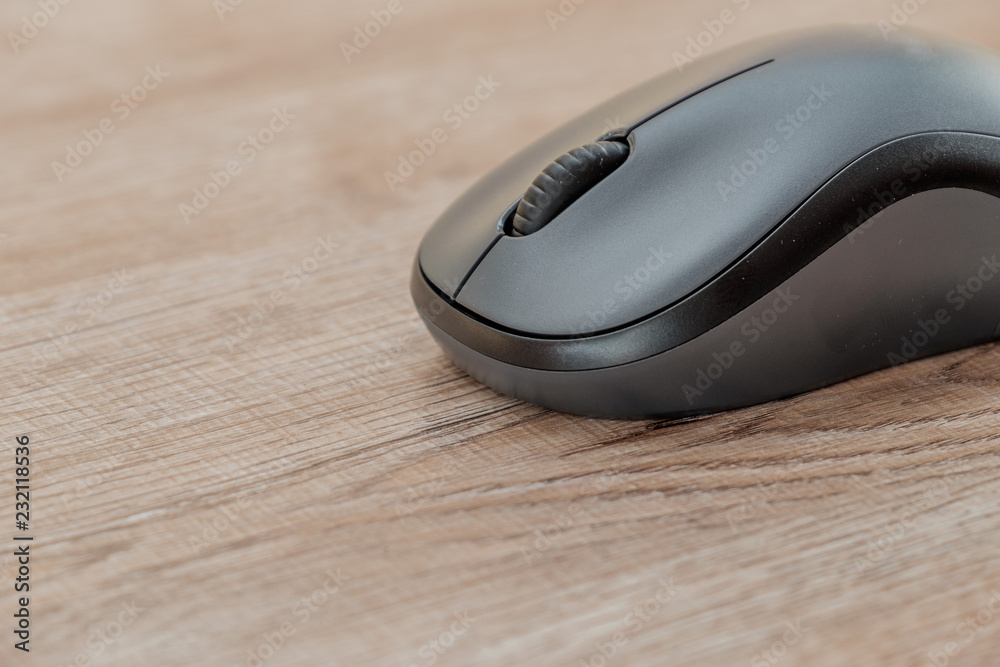 black computer mouse on wooden foor. black computer mouse on wooden foor.