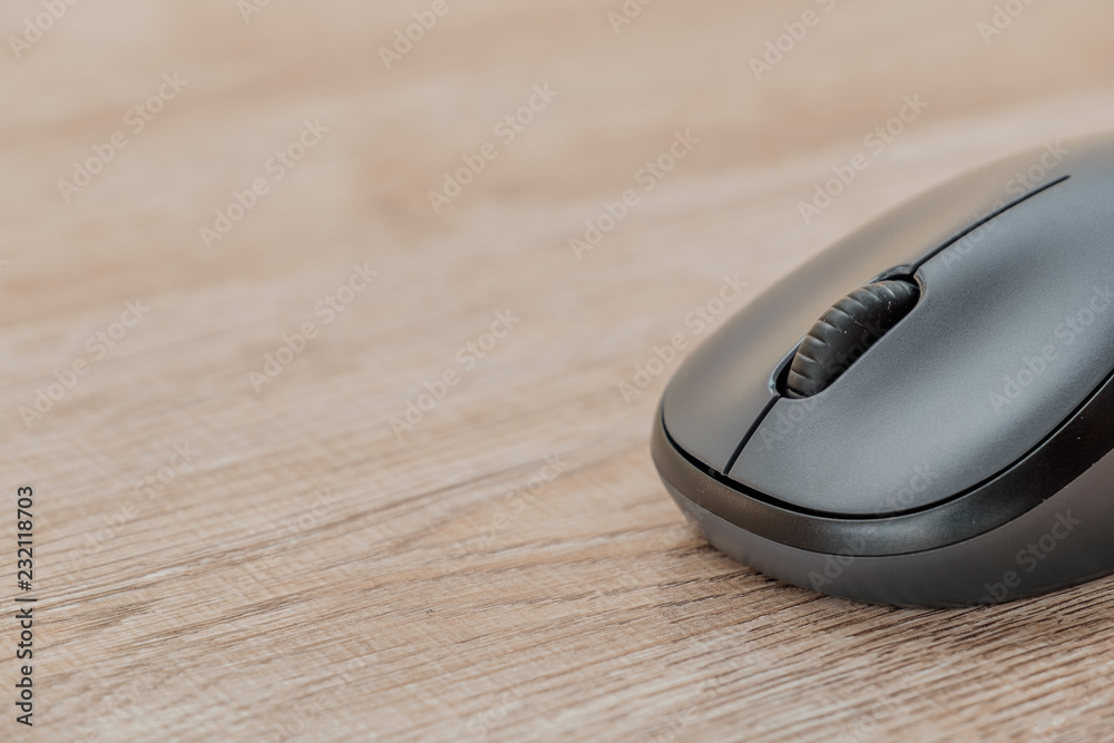 black computer mouse on wooden foor. black computer mouse on wooden foor.