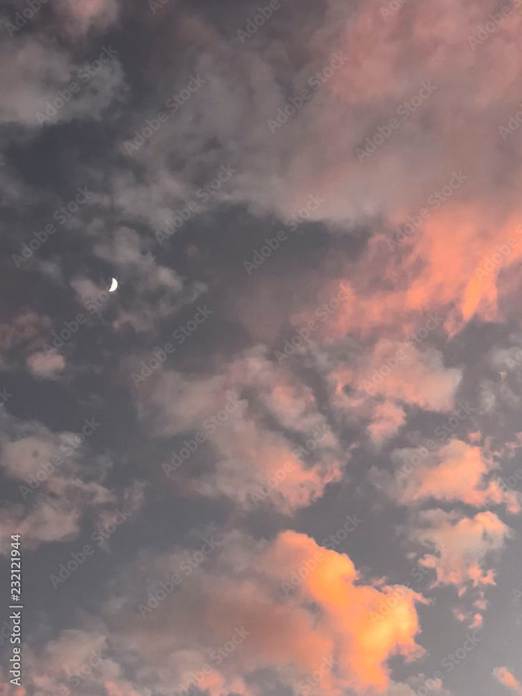 Orange and yellow colors sunset sky with moon.