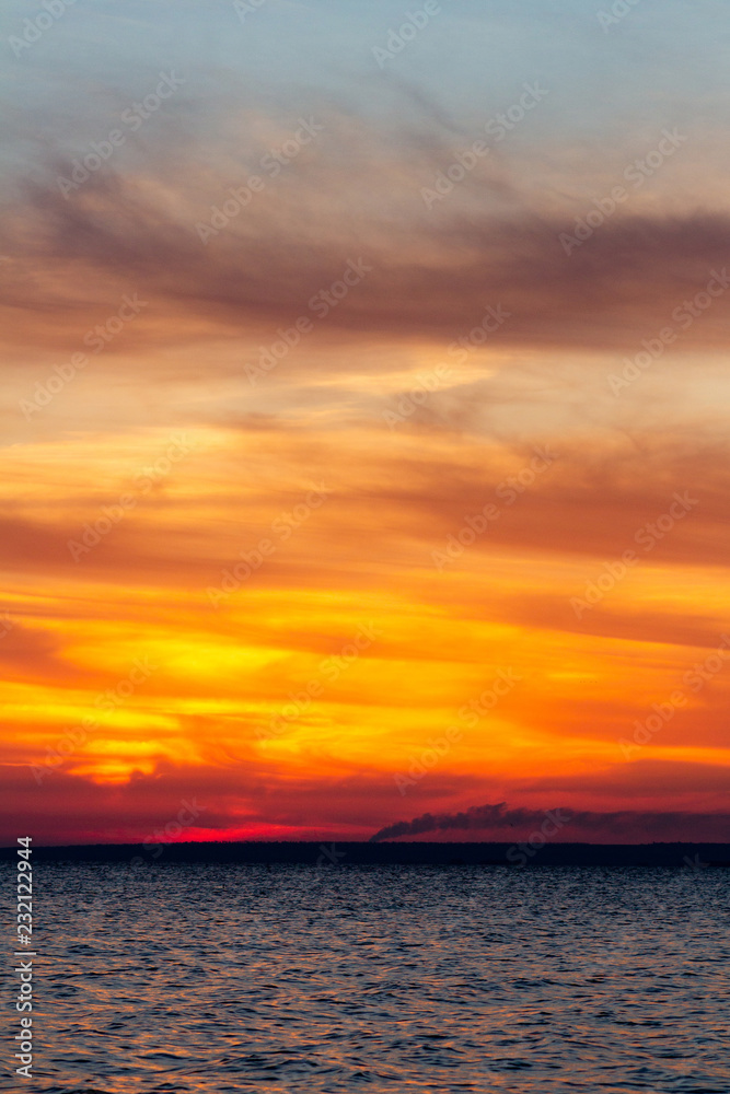 background of sunset on the sea, birds fly among the clouds lit by the rays of the sun background of sunset on the sea, birds fly among the clouds lit by the rays of the sun