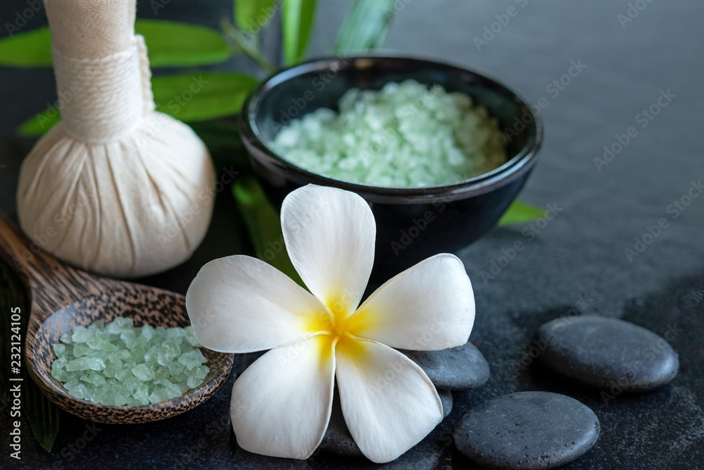 Thai spa composition treatments aroma therapy with candles and Plumeria flowers on wooden table close up. Healthy Concept Thai spa composition treatments aroma therapy with candles and Plumeria flowers on wooden table close up. Healthy Concept