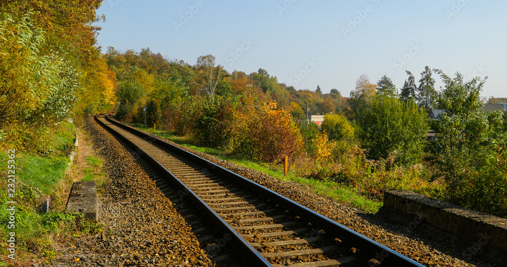 Railroad tracks view a view from the track from the bottom while moving slowly forward near the local forest on a sunny day at the end of the autumn. Railroad tracks view a view from the track from the bottom while moving slowly forward near the local forest on a sunny day at the end of the autumn.