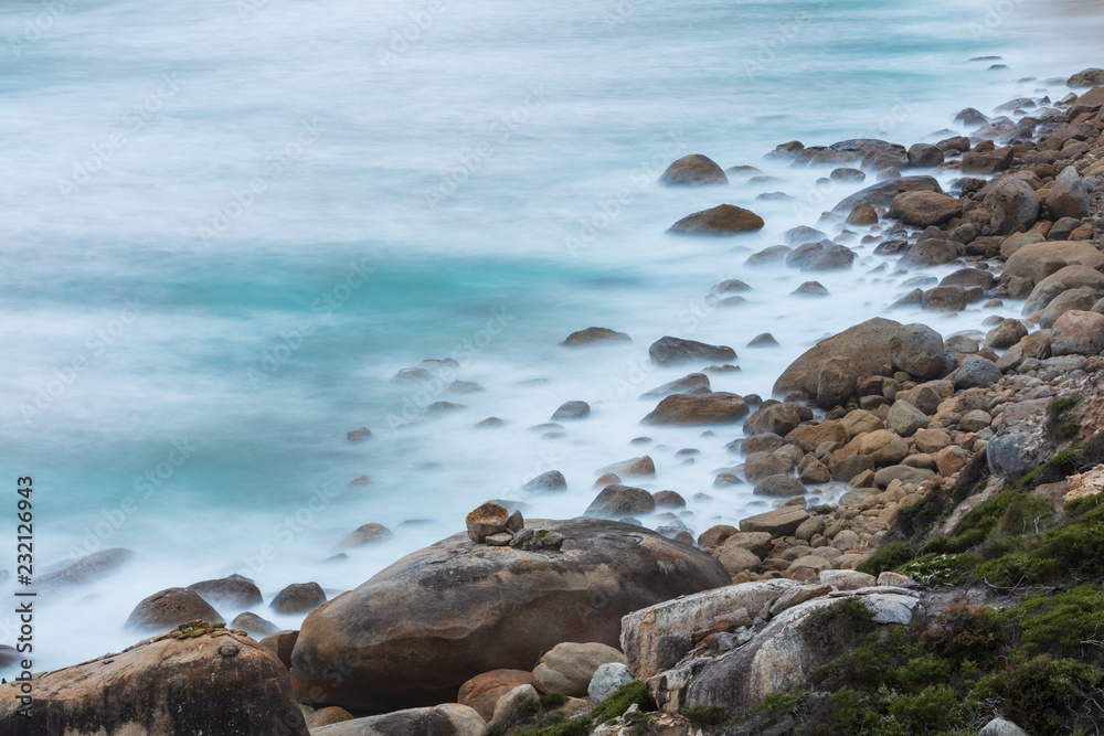 Long exposure of rocks and waves at Little Oberon bay in Wilsons Promontory national park, Victoria, Australia