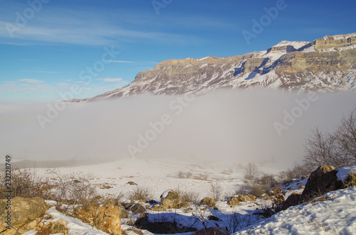 Scenic view of valley in cloud and mountain, lit with the sun. Nature and travel. Russia, North Caucasus, southern Dagestan, Dokuzparinsky District