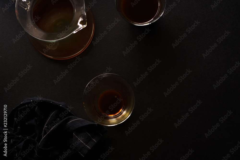 Pour over coffee in picther in two glasses on black background with black napkin. Overhead view Pour over coffee in picther in two glasses on black background with black napkin. Overhead view