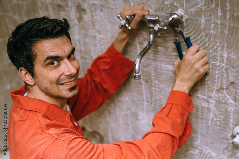 Naklejka premium Handyman removing the old tap