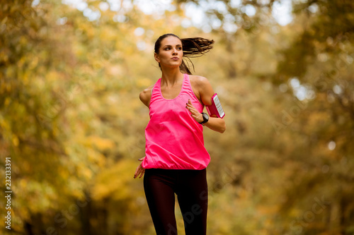 Fototapeta Naklejka Na Ścianę i Meble -  Healthy fitness woman training for marathon outdoors in alleyway