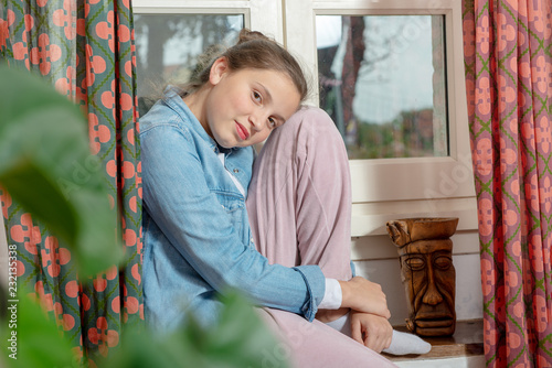 portrait of pretty  teenage girl near the window © Philipimage