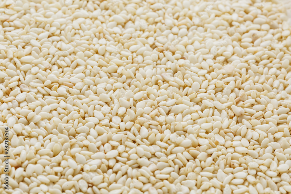 White sesame seeds background. Useful seeds for cooking