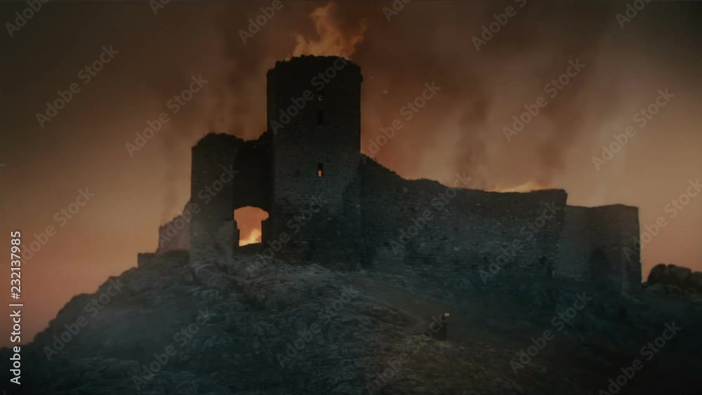 Fortress burning at sunset after medieval battle. 