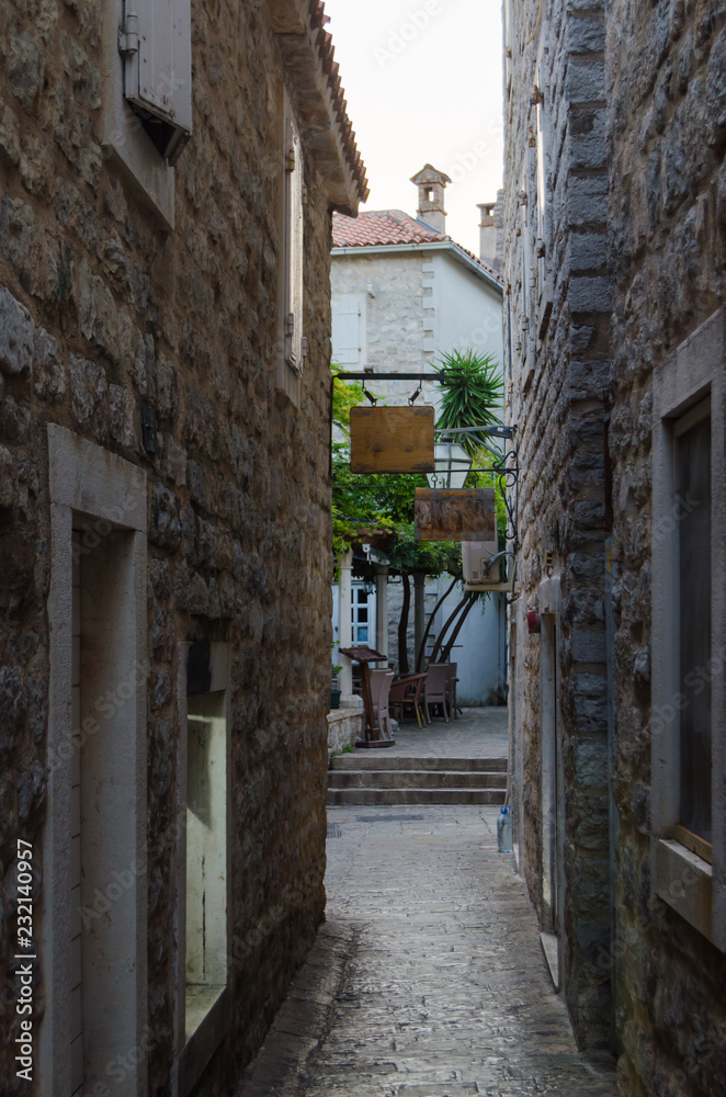 Narrow streets of the old stone town with stone blocks.