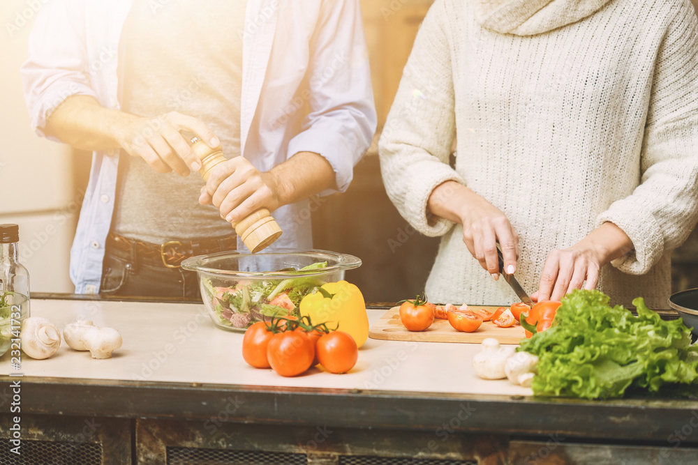 Lovely couple are talking and while cooking healthy food in kitchen at home. Close-Up. Lovely couple are talking and while cooking healthy food in kitchen at home. Close-Up.