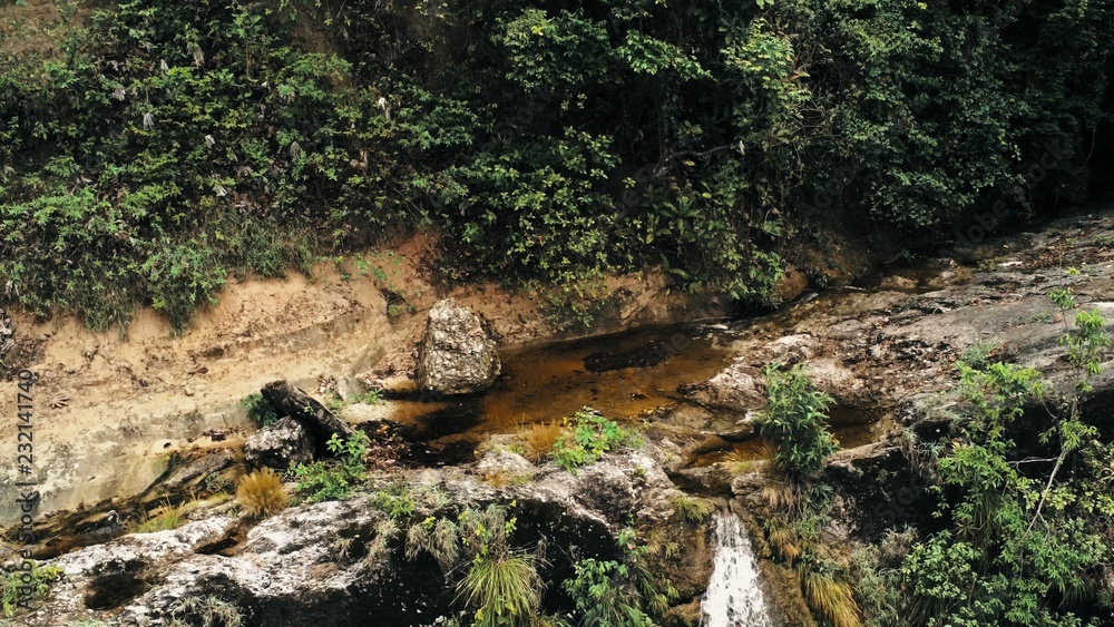 Cinematic aerial drone image of waterfall and a small pool deep in the rainforest jungle at Amboro National Park, Bolivia Cinematic aerial drone image of waterfall and a small pool deep in the rainforest jungle at Amboro National Park, Bolivia