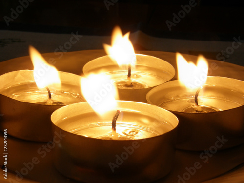 Four small lighted Advent candels in motion