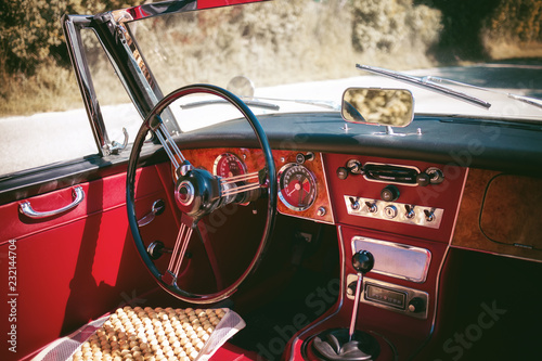 Cockpit of an old red vintage cabriolet sport car