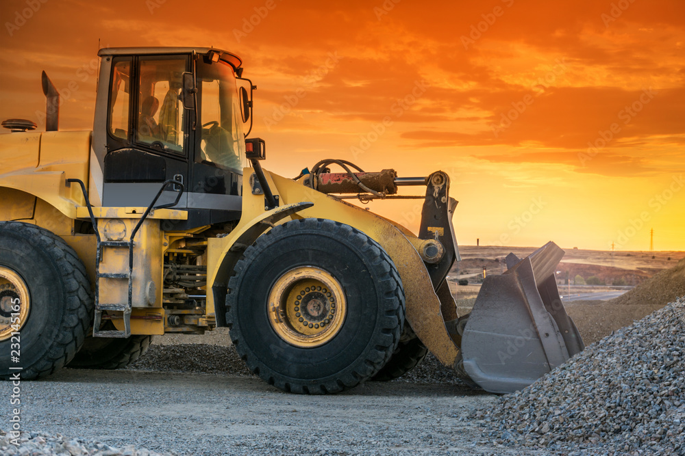 Excavator in a stone mine transporting and stacking gravel Excavator in a stone mine transporting and stacking gravel