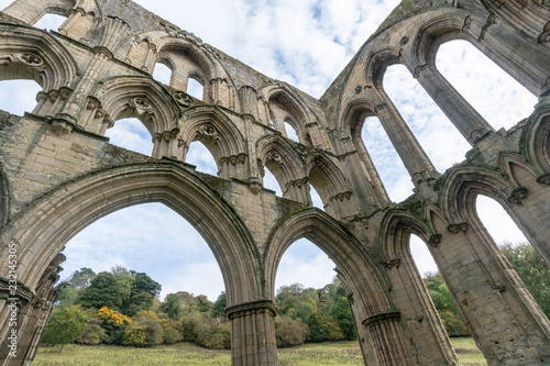 The ruins of the church Abbey. A shell of a building, stone walls and window arches largely intact but no roof photo