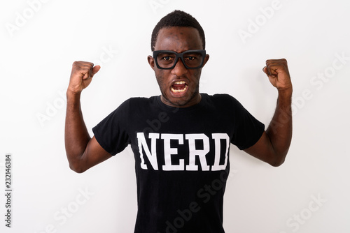 Studio shot of young black African geek man wearing Nerd shirt w