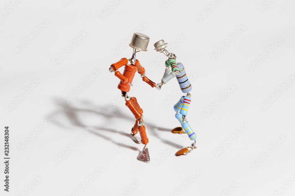 two funny small human figures, roughly welded from resistors and transistors, dance together on a light background two funny small human figures, roughly welded from resistors and transistors, dance together on a light background