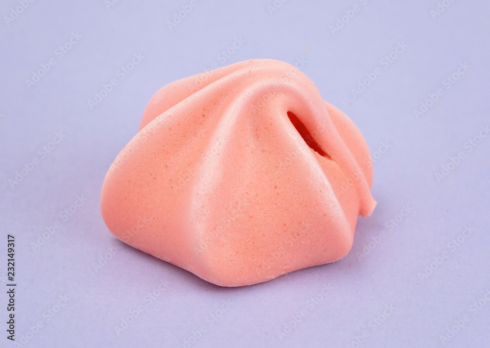 Single Meringue on a Purple Background Single Meringue on a Purple Background