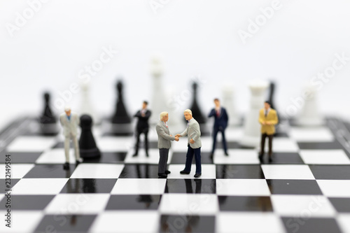 Miniature people, Group Businessmen standing on the chess game, thinking solution for the business game, use as a business competition concept.