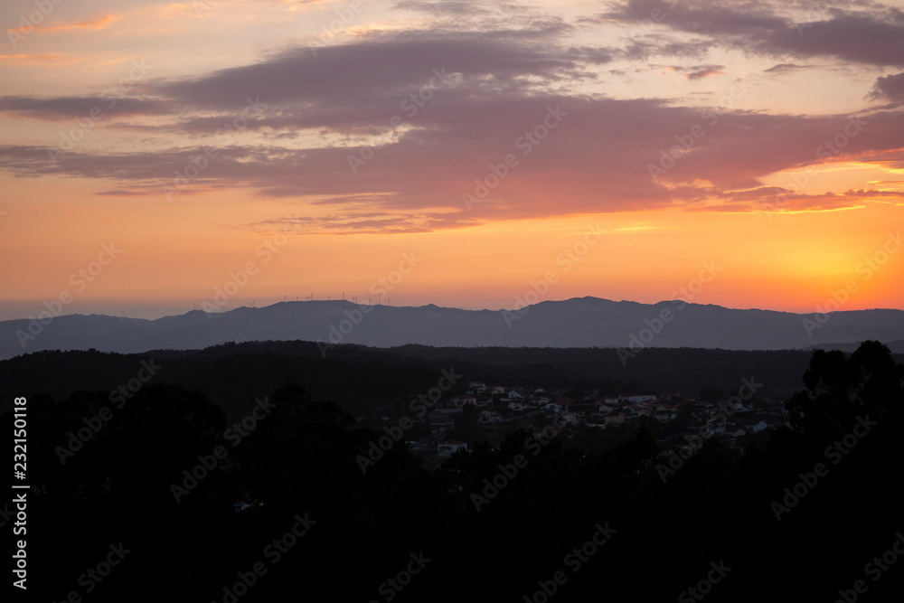 View of mountains with wind turbines and fantastic sky with sky