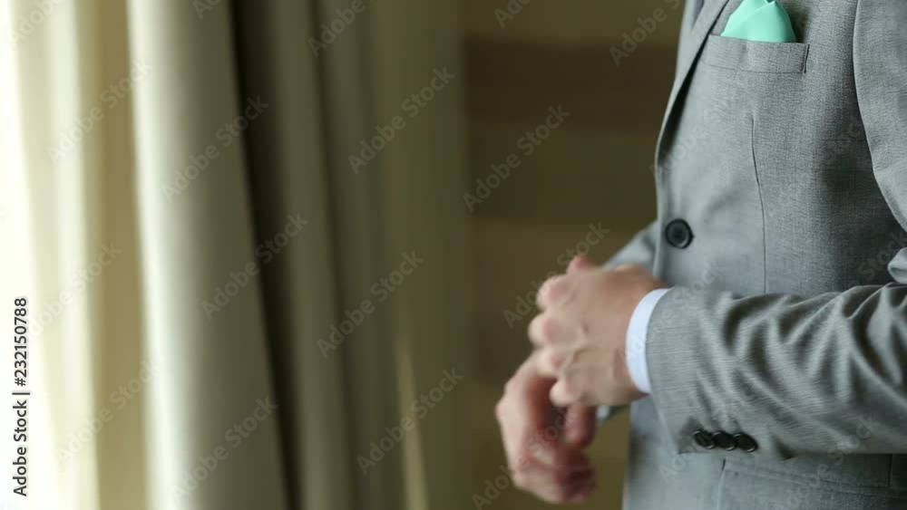 Groom, man correct sleeves on shirt, hands close-up, dressing, man's style. Sexy man buttons cuff-link on cuffs sleeves luxury white shirt. Groom, man correct sleeves on shirt, hands close-up, dressing, man's style. Sexy man buttons cuff-link on cuffs sleeves luxury white shirt.