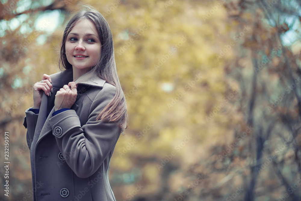 Young girl in a coat in autumn park Young girl in a coat in autumn park