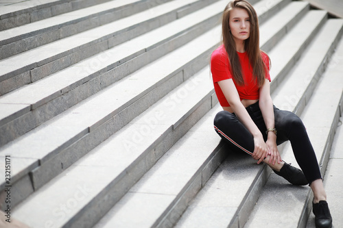 A girl posing on the steps of a building