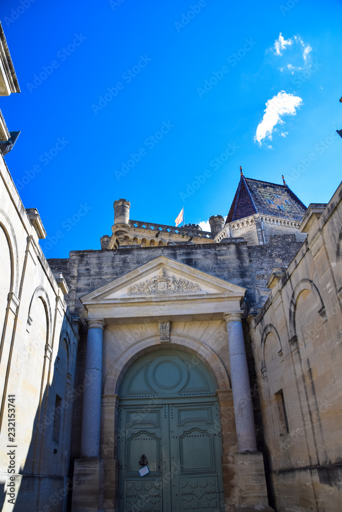 View of the Duchal Palace from the streets of the medieval village of Uzes in the Gard region of Provence, France
