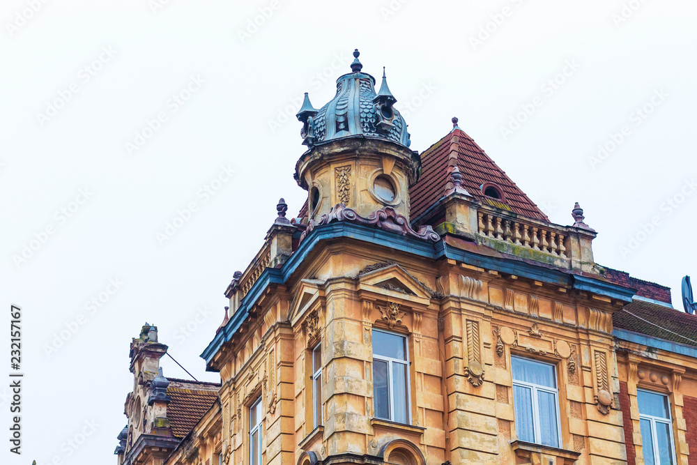 The top of an old building with rich decoration in a modern European city_