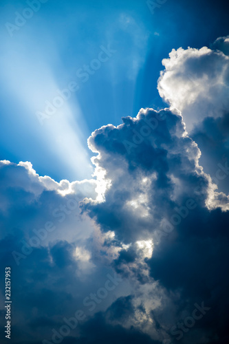 Fototapeta Naklejka Na Ścianę i Meble -  Heavenly light shining through billowing clouds in a stormy sky