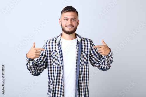 Young man in shirt on grey background