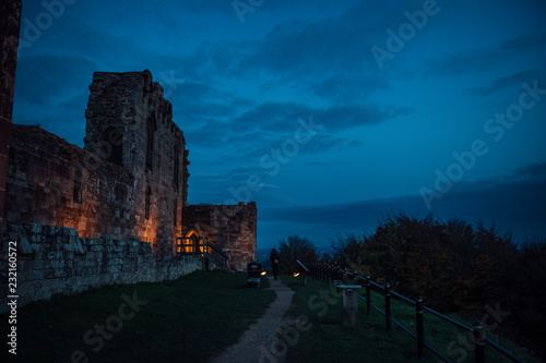 Beautiful sunset on ancient Stafford Castle with colorful sky and light on castle.