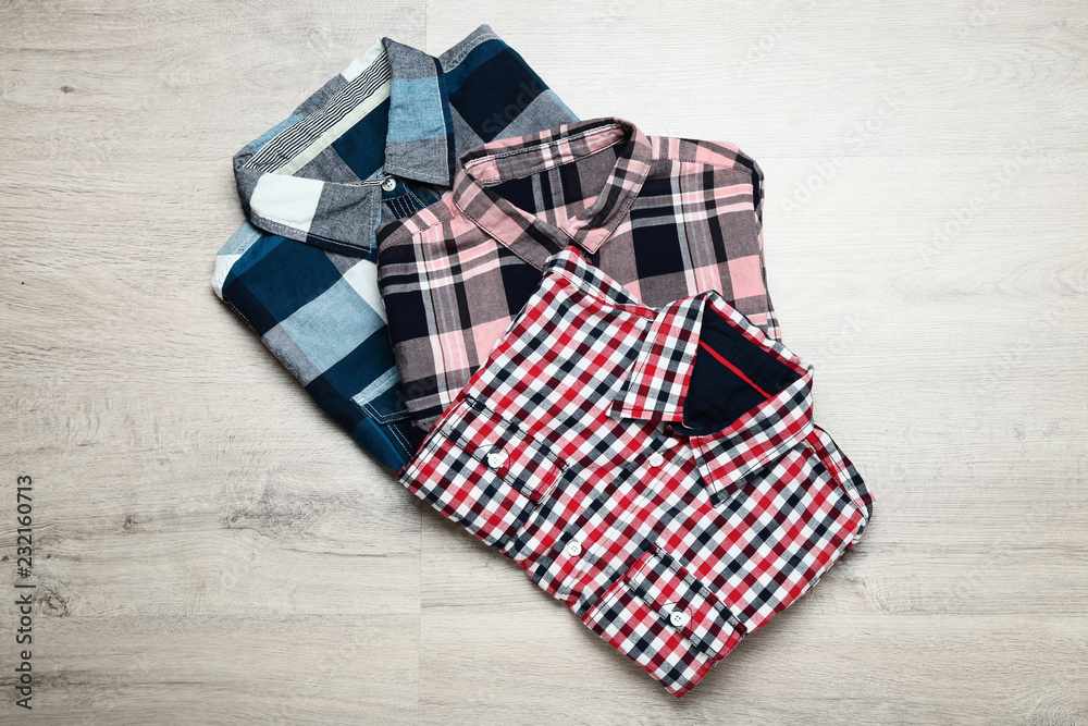 Folded shirts on wooden table Folded shirts on wooden table