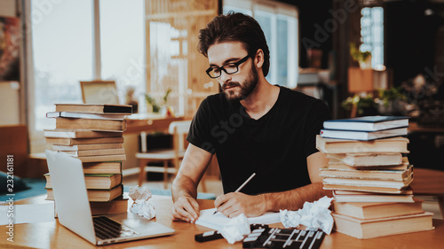 Pensive Freelance Text Writer Working at Desk photo