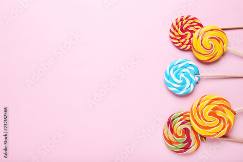 Colorful lollipops on pink background
