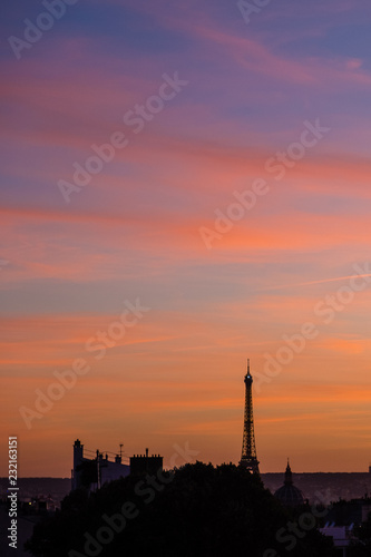 Paris skyline at sunset with silhouette of Eiffel Tower and colourful sky