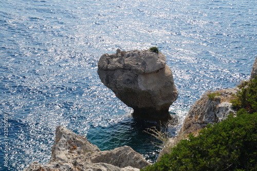Lonely rock in the sea in the form of a column