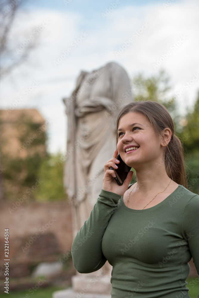 woman in foro romano talks on the smartphone woman in foro romano talks on the smartphone